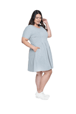 Curvy model facing the side wearing grey with white pin striped, knee length dress, featuring rounded neckline, fitted bodice, pleated A-line skirt and pockets. Kaitlyn available in sizes 6-26