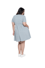 Curvy model facing the back wearing grey with white pin striped, knee length dress, featuring rounded neckline, fitted bodice, pleated A-line skirt and pockets. Kaitlyn available in sizes 6-26