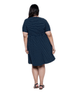 Curvy model facing the back wearing navy with white pin striped, knee length dress, featuring rounded neckline, fitted bodice, pleated A-line skirt and pockets. Kaitlyn available in sizes 6-26