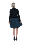 Petite model facing the back wearing navy with white pin striped, knee length dress and black blazer, featuring rounded neckline, fitted bodice, pleated A-line skirt and pockets. Kaitlyn available in sizes 6-26