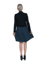 Petite model facing the back wearing navy with white pin striped, knee length dress and black blazer, featuring rounded neckline, fitted bodice, pleated A-line skirt and pockets. Kaitlyn available in sizes 6-26