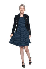 Petite model facing the camera wearing navy with white pin striped, knee length dress and black blazer, featuring rounded neckline, fitted bodice, pleated A-line skirt and pockets. Kaitlyn available in sizes 6-26