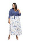 Curvy model facing camera wearing maxi dress with blue mid sleeved crossover top attached to white skirt with blue and tan watercolour accents. Mai available in sizes 6-26