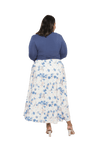 Curvy model facing the back wearing maxi dress with blue mid sleeved crossover top attached to white skirt with blue and tan watercolour accents. Mai available in sizes 6-26