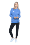 Petite model facing camera wearing cornflour blue hoodie, featuring front pocket, and white Mama print across the chest. Mama hoodie available in sizes 6-26