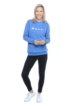 Petite model facing camera wearing cornflour blue hoodie, featuring front pocket, and white Mama print across the chest. Mama hoodie available in sizes 6-26