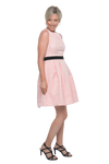 Petite model facing the side wearing pink cocktail dress, featuring a boat neckline, back zip and a feature black sash across the waist. Marie available in sizes 6-18