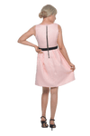 Petite model facing the back wearing pink cocktail dress, featuring a boat neckline, back zip and a feature black sash across the waist. Marie available in sizes 6-18