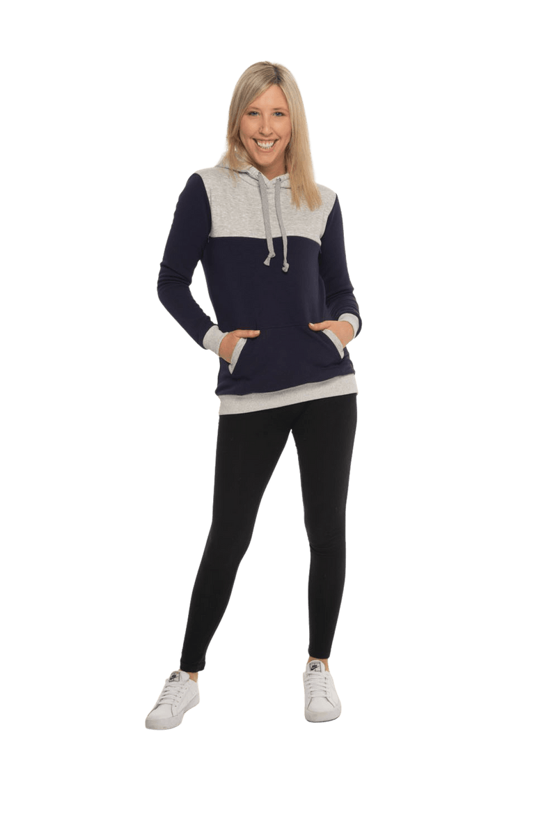 Petite model facing camera wearing navy hoodie with grey panel over chest, shoulders, and top of back, featuring front pocket, and grey highlights at pocket openings and sleeve cuffs. Olivia hoodie available in sizes 6-26