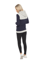 Petite model facing the back wearing navy hoodie with grey panel over chest, shoulders, and top of back, featuring front pocket, and grey highlights at pocket openings and sleeve cuffs. Olivia hoodie available in sizes 6-26