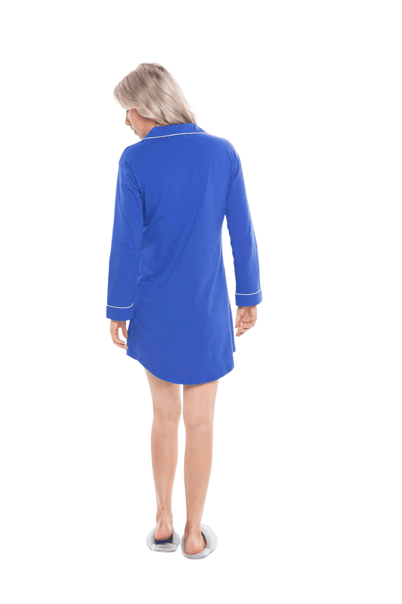 Petite model facing the back wearing royal blue button up, mid thigh length pyjama shirt, featuring fold over collar, scooped hemline, and white piping. Parker available in sizes 6-18