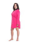 Brunette model facing the side wearing royal blue button up, mid thigh length pyjama shirt, featuring fold over collar, scooped hemline, and white piping. Parker available in sizes 6-18