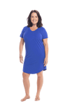 Brunette model facing camera wearing royal blue mid thigh length nightie, featuring rounded neckline, scooped hemline with short sleeves. Penny available in sizes 6-18
