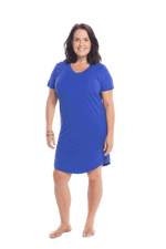 Brunette model facing camera wearing royal blue mid thigh length nightie, featuring rounded neckline, scooped hemline with short sleeves. Penny available in sizes 6-18