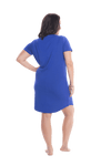 Brunette model facing the back wearing royal blue mid thigh length nightie, featuring rounded neckline, scooped hemline with short sleeves. Penny available in sizes 6-18
