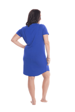 Brunette model facing the back wearing royal blue mid thigh length nightie, featuring rounded neckline, scooped hemline with short sleeves. Penny available in sizes 6-18