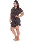 Curvy model facing the side wearing black with small red rose patterned mid thigh length nightie, featuring rounded neckline, scooped hemline with short sleeves. Penny available in sizes 6-18