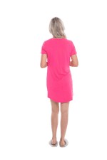 Blonde model facing the back wearing hot pink mid thigh length nightie, featuring rounded neckline, scooped hemline with short sleeves. Penny available in sizes 6-18