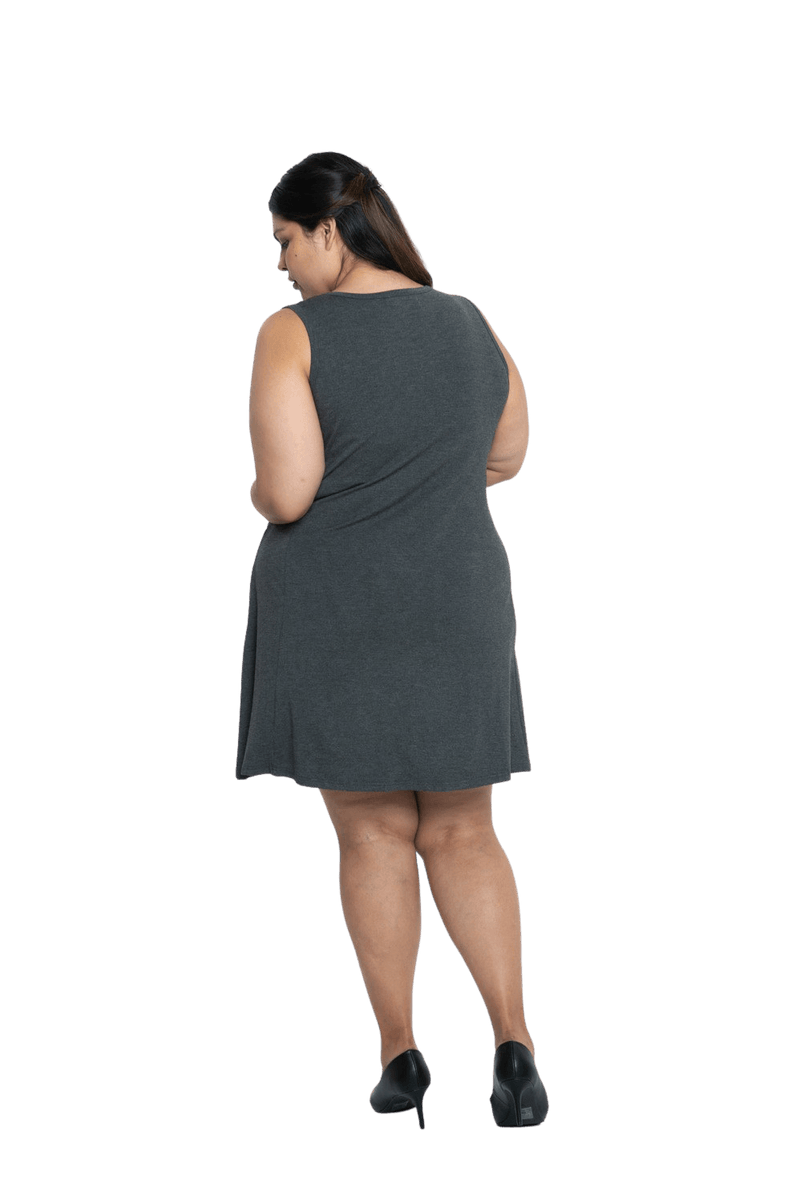 Curvy model facing the back wearing charcoal grey mid thigh length dress, featuring rounded neckline, pockets and a waist sash tied at the front. Peyton available in sizes 6-26