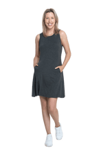 Petite model facing camera wearing charcoal grey mid thigh length dress, featuring rounded neckline, pockets and a waist sash tied at the back. Peyton available in sizes 6-26