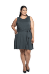 Curvy model facing camera wearing charcoal grey mid thigh length dress, featuring rounded neckline, pockets and a waist sash tied at the front. Peyton available in sizes 6-26