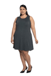 Curvy model facing camera wearing charcoal grey mid thigh length dress, featuring rounded neckline, pockets and a waist sash tied at the back. Peyton available in sizes 6-26