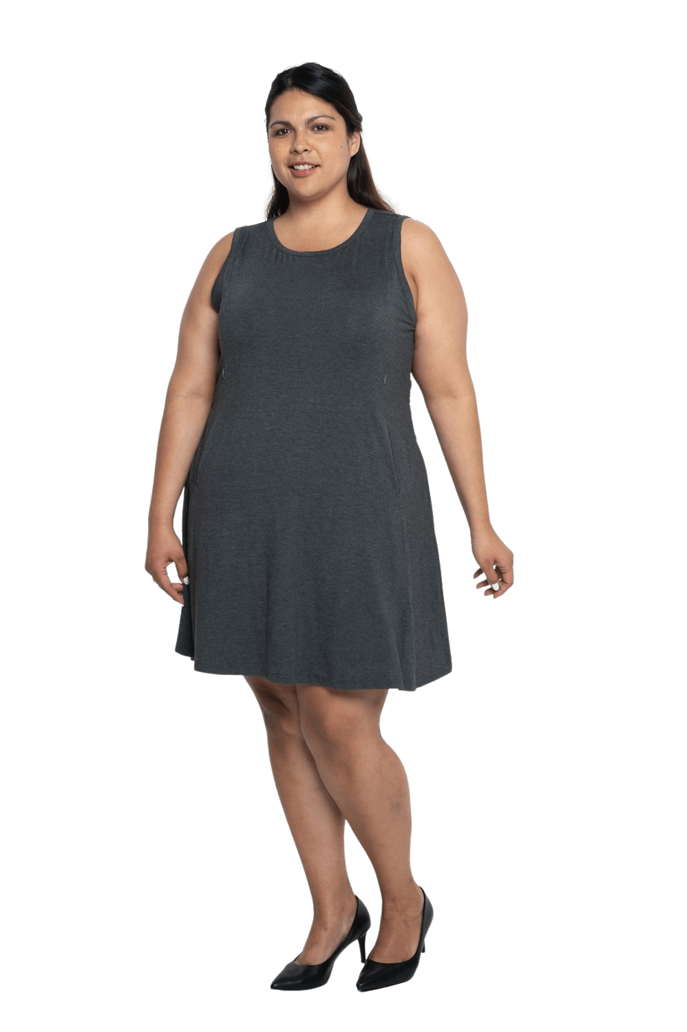 Curvy model facing camera wearing charcoal grey mid thigh length dress, featuring rounded neckline, pockets and a waist sash tied at the back. Peyton available in sizes 6-26