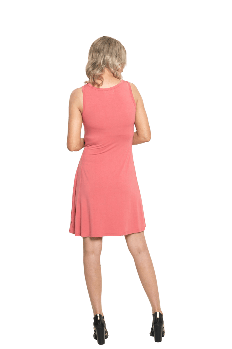 Petite model facing the back wearing dusty pink mid thigh length dress, featuring rounded neckline, pockets and a waist sash tied at the front. Peyton available in sizes 6-26