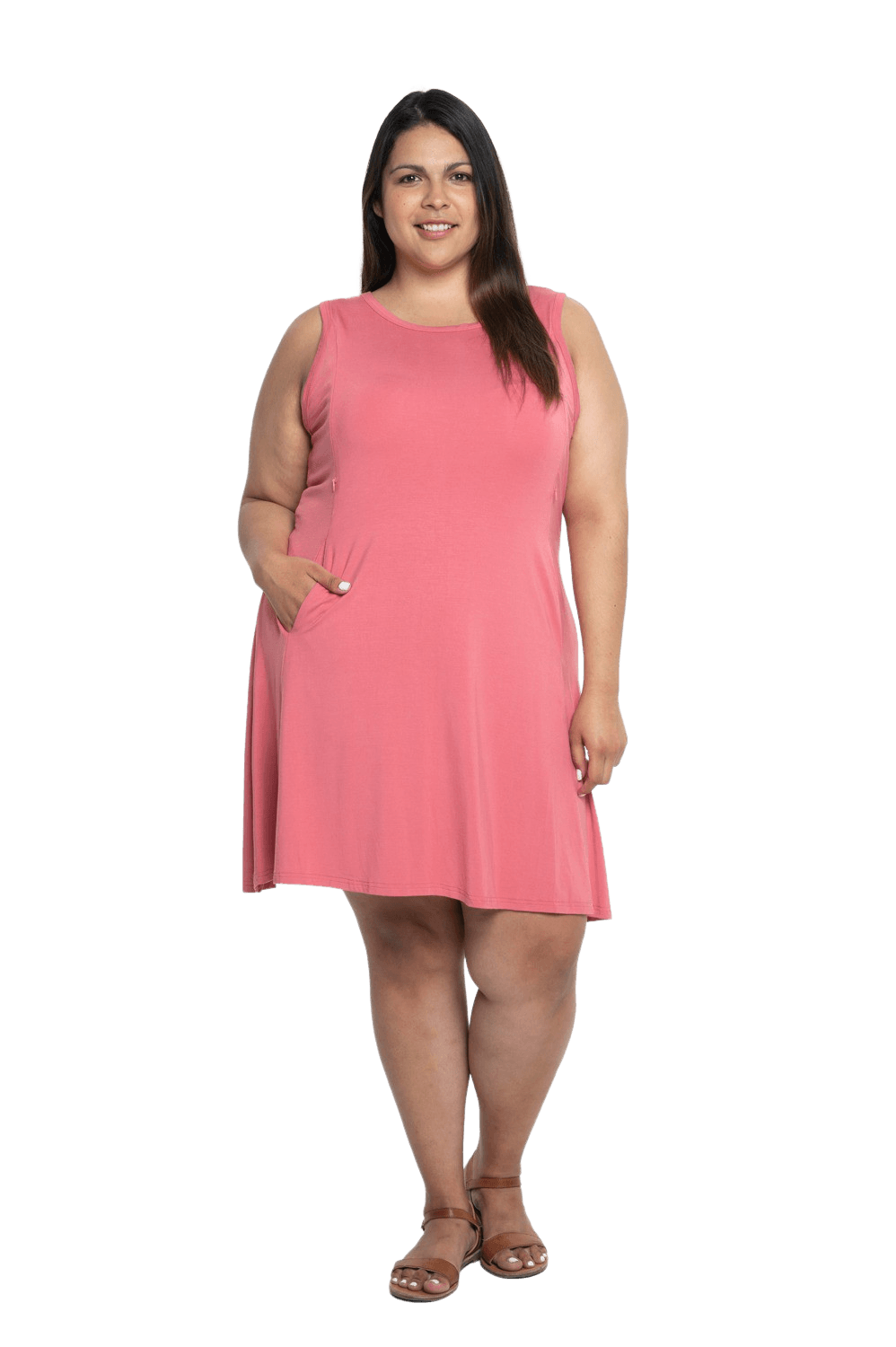 Curvy model facing camera wearing dusty pink mid thigh length dress, featuring rounded neckline, pockets and a waist sash tied at the back. Peyton available in sizes 6-26