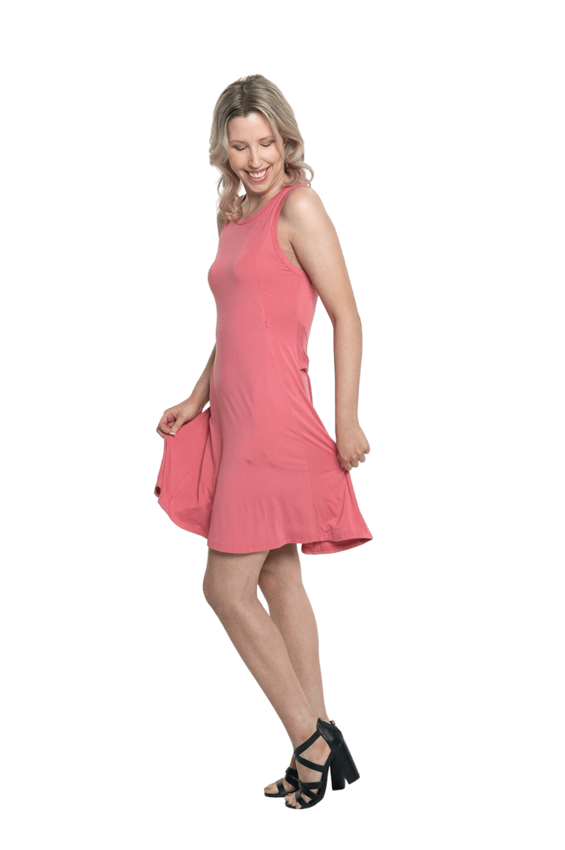 Petite model facing the side wearing dusty pink mid thigh length dress, featuring rounded neckline, pockets and a waist sash tied at the front. Peyton available in sizes 6-26