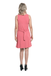 Petite model facing the back wearing dusty pink mid thigh length dress, featuring rounded neckline, pockets and a waist sash tied at the back. Peyton available in sizes 6-26