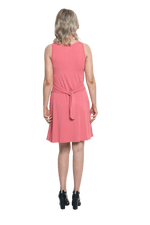 Petite model facing the back wearing dusty pink mid thigh length dress, featuring rounded neckline, pockets and a waist sash tied at the back. Peyton available in sizes 6-26