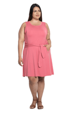 Curvy model facing camera wearing dusty pink mid thigh length dress, featuring rounded neckline, pockets and a waist sash tied at the front. Peyton available in sizes 6-26