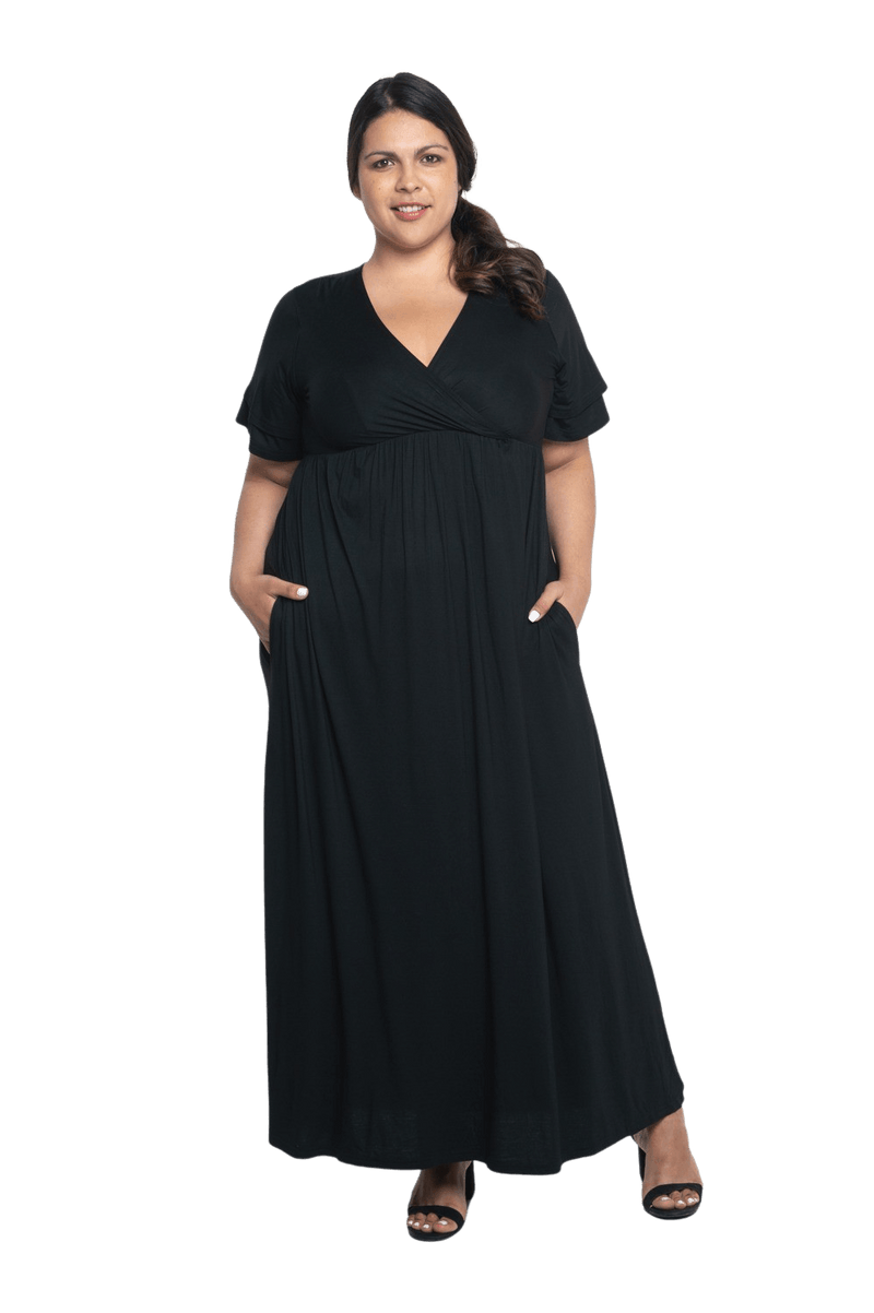 Curvy model facing camera wearing black maxi dress, featuring crossover V-neck, double layer detailed sleeves, pockets and a beautiful Grecian flowing silhouette. Phoebe available in sizes 6-26