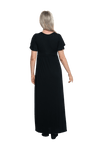 Petite model facing the back wearing black maxi dress, featuring crossover V-neck, double layer detailed sleeves, pockets and a beautiful Grecian flowing silhouette. Phoebe available in sizes 6-26