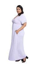 Curvy model facing the side wearing lilac maxi dress, featuring crossover V-neck, double layer detailed sleeves, pockets and a beautiful Grecian flowing silhouette. Phoebe available in sizes 6-26