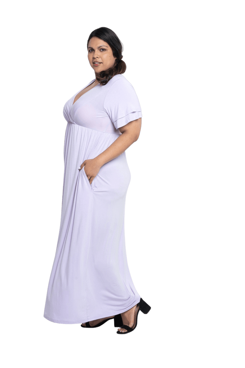Curvy model facing the side wearing lilac maxi dress, featuring crossover V-neck, double layer detailed sleeves, pockets and a beautiful Grecian flowing silhouette. Phoebe available in sizes 6-26