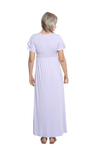 Petite model facing the back wearing lilac maxi dress, featuring crossover V-neck, double layer detailed sleeves, pockets and a beautiful Grecian flowing silhouette. Phoebe available in sizes 6-26