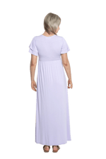 Petite model facing the back wearing lilac maxi dress, featuring crossover V-neck, double layer detailed sleeves, pockets and a beautiful Grecian flowing silhouette. Phoebe available in sizes 6-26