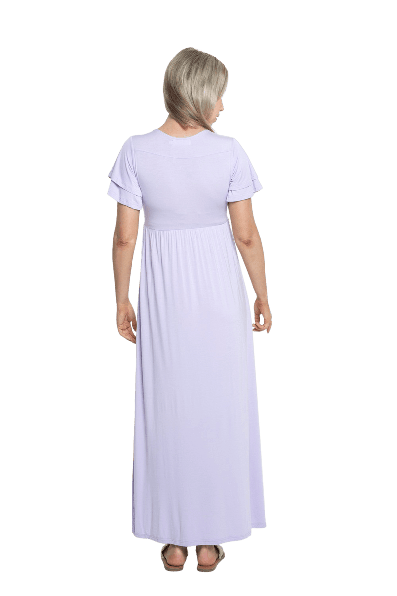 Petite model facing the back wearing lilac maxi dress, featuring crossover V-neck, double layer detailed sleeves, pockets and a beautiful Grecian flowing silhouette. Phoebe available in sizes 6-26