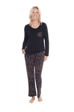 Petite model facing the camera wearing long sleeved pyjamas with pants. Top is black with contrast breast pocket matching pants. Pants are black with small red rose pattern, featuring pockets, and elasticated waist with pull tie. Piper available in sizes 6-26
