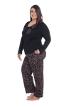 Curvy model facing the side wearing long sleeved pyjamas with pants. Top is black with contrast breast pocket matching pants. Pants are black with small red rose pattern, featuring pockets, and elasticated waist with pull tie. Piper available in sizes 6-26