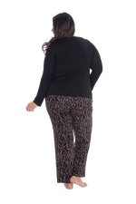 Curvy model facing the back wearing long sleeved pyjamas with pants. Top is black with contrast breast pocket matching pants. Pants are black with small red rose pattern, featuring pockets, and elasticated waist with pull tie. Piper available in sizes 6-26