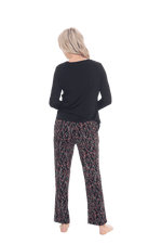 Petite model facing the back wearing long sleeved pyjamas with pants. Top is black with contrast breast pocket matching pants. Pants are black with small red rose pattern, featuring pockets, and elasticated waist with pull tie. Piper available in sizes 6-26