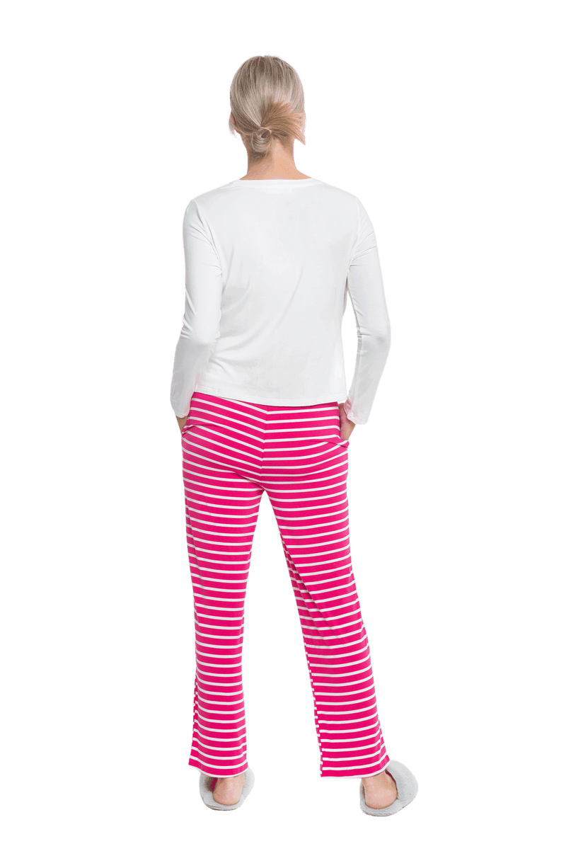 Petite model facing the back wearing long sleeved pyjamas with pants. Top is white with contrast breast pocket matching pants. Pants are hot pink and white stripe, featuring pockets, and elasticated waist with pull tie. Piper available in sizes 6-18