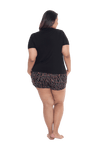 Curvy model facing the back wearing short sleeved pyjamas with shorts. Top is black with contrast breast pocket matching shorts. Shorts are black with small red rose pattern, featuring pockets, and elasticated waist with pull tie. Poppy available in sizes 6-26