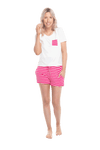 Petite model facing the camera wearing short sleeved pyjamas with shorts. Top is white with contrast breast pocket matching shorts. Shorts are hot pink and white stripe, featuring pockets, and elasticated waist with pull tie. Poppy available in sizes 6-18