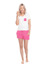 Petite model facing the camera wearing short sleeved pyjamas with shorts. Top is white with contrast breast pocket matching shorts. Shorts are hot pink and white stripe, featuring pockets, and elasticated waist with pull tie. Poppy available in sizes 6-18