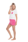 Petite model facing the side wearing short sleeved pyjamas with shorts. Top is white with contrast breast pocket matching shorts. Shorts are hot pink and white stripe, featuring pockets, and elasticated waist with pull tie. Poppy available in sizes 6-18