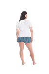 Brunette model facing the back wearing long sleeved pyjamas with pants. Top is white with contrast breast pocket matching pants. Pants are teal and white stripe, featuring pockets, and elasticated waist with pull tie. Piper available in sizes 6-18